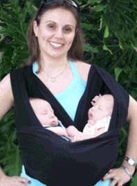 Proud momma carrying her twins in a sling